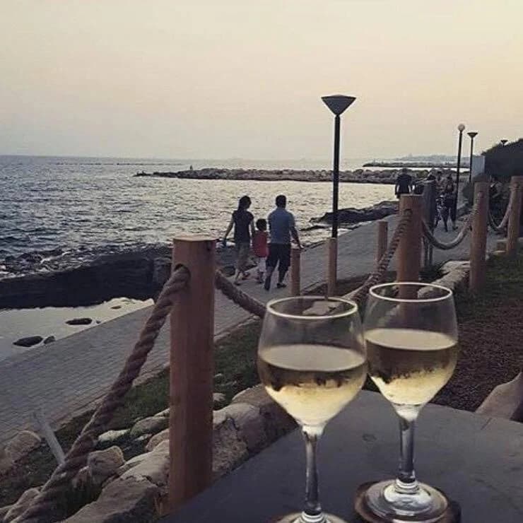 Two glasses of white wine by the sea